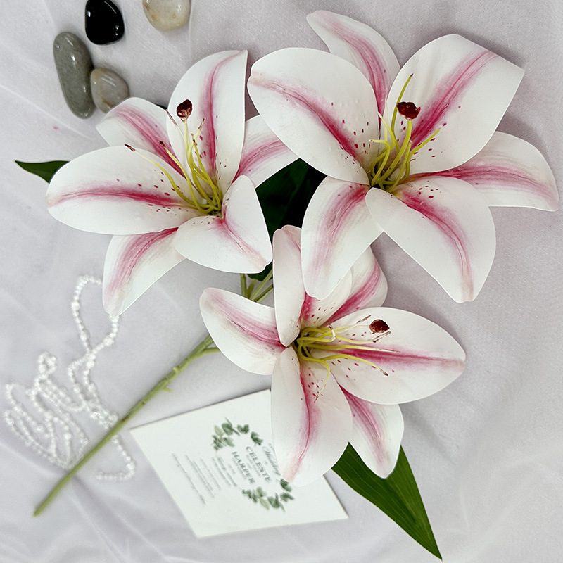 Fake lily flowers are made of 3D printing cloth, available in 10 colors. Lily artificial flowers are used for Car Decor、Exhibition、Home Decor、Hotel Decor、Office Decor. In terms of décor, the Peace Lily can be used as a focal point in a room or as a complement to other decorative elements. . Lily flower arrangement can be matched with Delphinium、Viburnum、Hydrangea、Roses、Jasmine、Celosia、Miscanthus、Zinnias、Cosmos、Branches、dahlias、button poms、Ruscus、Chrysanthemums、Grasses and greenery ect. Leafhometrade specializes in providing wholesale custom artificial plants.