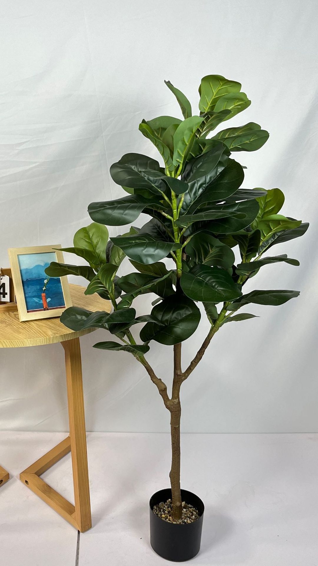 Faux fiddle fig tree are made of Feel glue, environmentally friendly plastic. Artificial trees with extremely realistic appearance can decorate hotels, casinos, restaurants, shopping malls, retail stores, apartment and office buildings, theaters, stadiums and private homes. Artificial trees can be reused for many years, which makes the initial investment a significant saving in the long run, especially when you consider the maintenance costs required for certain types of trees. Once installed, artificial trees require no maintenance, watering and cleaning, except for occasional dusting when the situation requires it. Leafhometrade specializes in providing wholesale custom artificial plants.