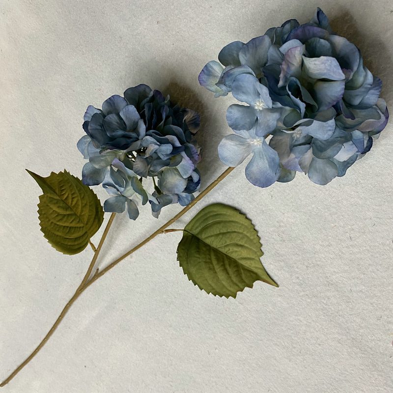 Artificial hydrangeas are made of fabric cloth, available in 10 colors. Artificial hydrangeas flowers are used for ‎Home decoration, party venue decoration, wedding venue decoration, exquisite bouquet design, flower box design, flower basket design. Hydrangea flower arrangements can be paired with delphiniums, freesias, foxgloves, greenery, bells, and more. Use hydrangeas in different colors to create a more vibrant floral arrangement for special occasions. Add some greenery to your flower arrangement to fill in the gaps and add visual interest. Use a vase or container in the same color as the hydrangeas for a more cohesive look. Leafhometrade specializes in providing wholesale custom artificial plants.