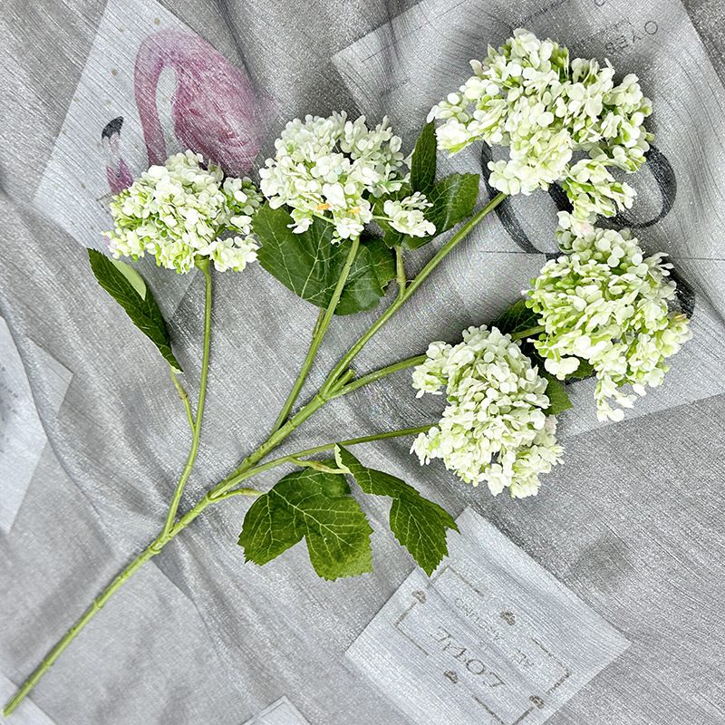 Artificial hydrangeas are made of plastic cloth, available in 11 colors. Artificial hydrangeas flowers are used for ‎Home decoration, party venue decoration, wedding venue decoration, exquisite bouquet design, flower box design, flower basket design. Hydrangea flower arrangements can be paired with delphiniums, freesias, foxgloves, greenery, bells, and more. Use hydrangeas in different colors to create a more vibrant floral arrangement for special occasions. Add some greenery to your flower arrangement to fill in the gaps and add visual interest. Use a vase or container in the same color as the hydrangeas for a more cohesive look. Leafhometrade specializes in providing wholesale custom artificial plants.