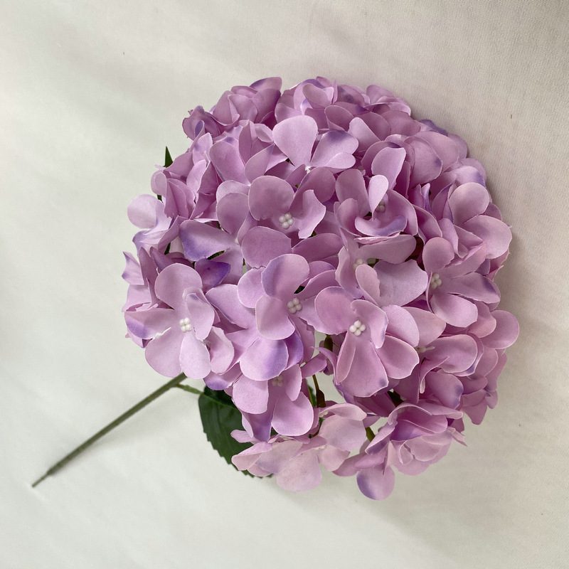 Artificial hydrangeas are made of fabric cloth, available in 12 colors. Artificial hydrangeas flowers are used for ‎Home decoration, party venue decoration, wedding venue decoration, exquisite bouquet design, flower box design, flower basket design. Hydrangea flower arrangements can be paired with delphiniums, freesias, foxgloves, greenery, bells, and more. Use hydrangeas in different colors to create a more vibrant floral arrangement for special occasions. Add some greenery to your flower arrangement to fill in the gaps and add visual interest. Use a vase or container in the same color as the hydrangeas for a more cohesive look. Leafhometrade specializes in providing wholesale custom artificial hydrangea flower.